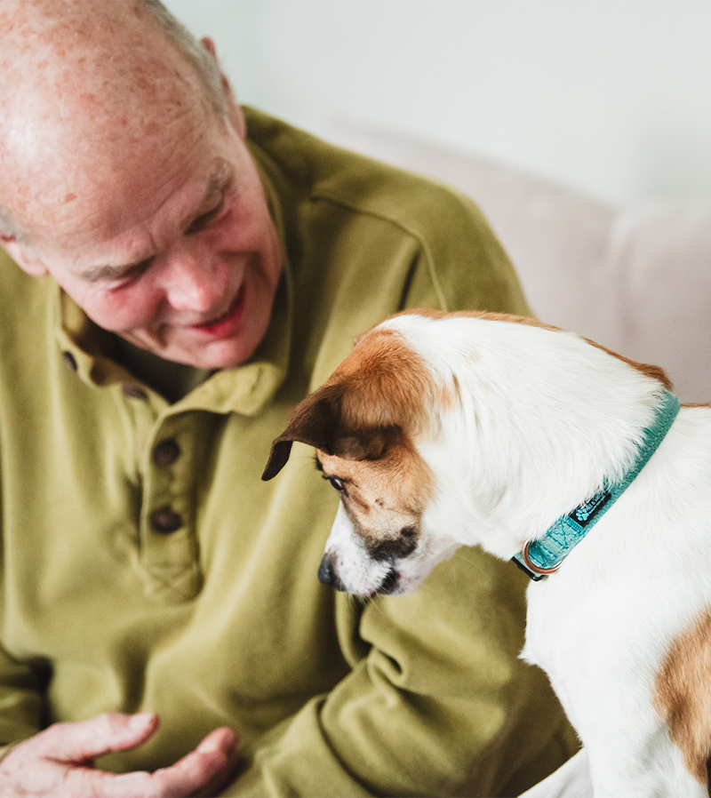 private-dog-training-in-home-1 Man connects with his dog after an animal communication session with animal communicator Lisa Lucas.